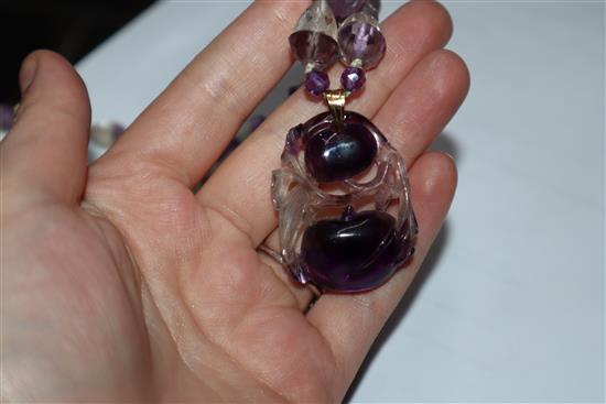 A Chinese amethyst and rock crystal pendant hung from a carved amethyst and rock crystal necklace, pendant 38mm.